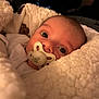 Hector participe au concours pour gagner de l'argent avec cette photo : baby, pacifier, blanket, infant, face, eyes, closeup, warm, soft, cute, newborn, child, sleepwear, cozy, indoor, portrait, comfort, fuzzy, resting, human