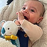 Hector participe au concours pour gagner de l'argent avec cette photo : baby, blanket, blue_clothing, button, child, close_up, cozy, cute, face, hand, happy, head, indoors, infant, koala, plush_toy, portrait, skin, smiling, soft_texture