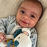 Hector participe au concours pour gagner de l'argent avec cette photo : baby, baby_clothing, blanket, child, closeup, comfort, cozy, cute, face, hand, indoor, infant, lying_down, onesie, plush_toy, portrait, sleepwear, smile, soft_toy, toddler
