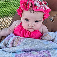 Melody is registered to the contest to win money with this photo: baby, child, towel, pink_swimsuit, swim_cap, strawberry_pattern, blue_eyes, curly_hair, tattoo, necklace, adult, holding, outdoor, chain_link_fence, summer, skin, portrait, closeup, person, cute