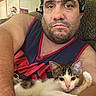 Ranger joined the competition — help win amazing prizes! man, kitten, cat, pet, indoor, couch, furniture, casual, portrait, relaxed, living_room, headset, face, arm, shirt, expressionless, animal, domestic_animal, home, resting