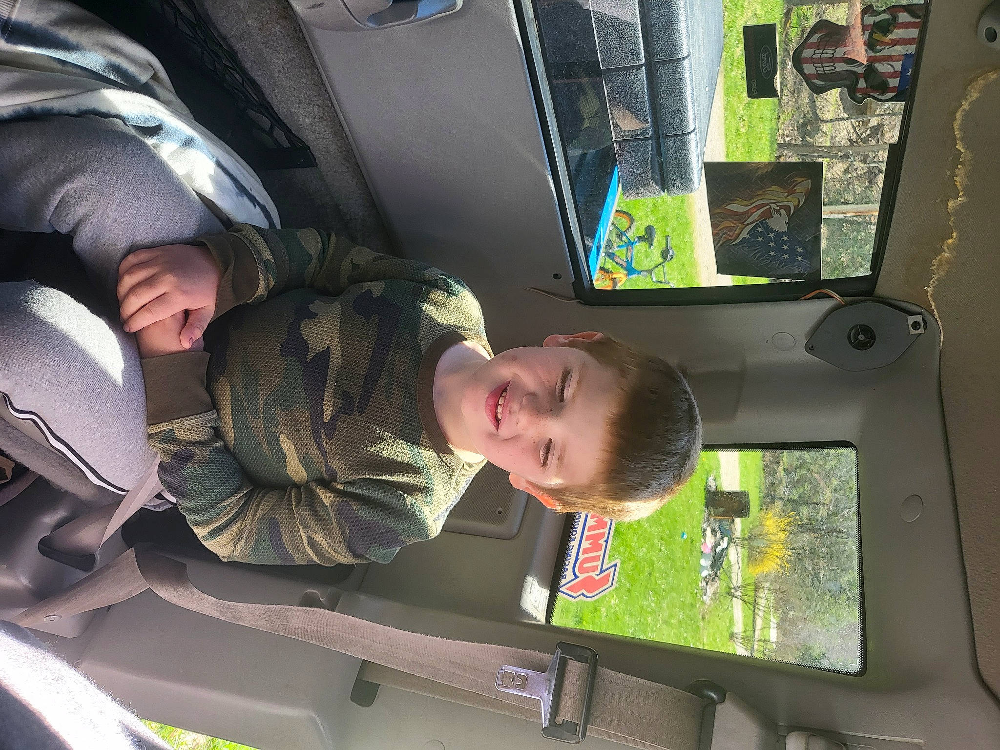 Aydin is registered to the contest to win money with this photo: auto_part, automotive_exterior, automotive_window_part, car_seat, car_seat_cover, display_device, family_car, fun, green, head_restraint, joy, machine, mode_of_transport, motor_vehicle, passenger, person, public_transport, t_shirt, toddler, vehicle