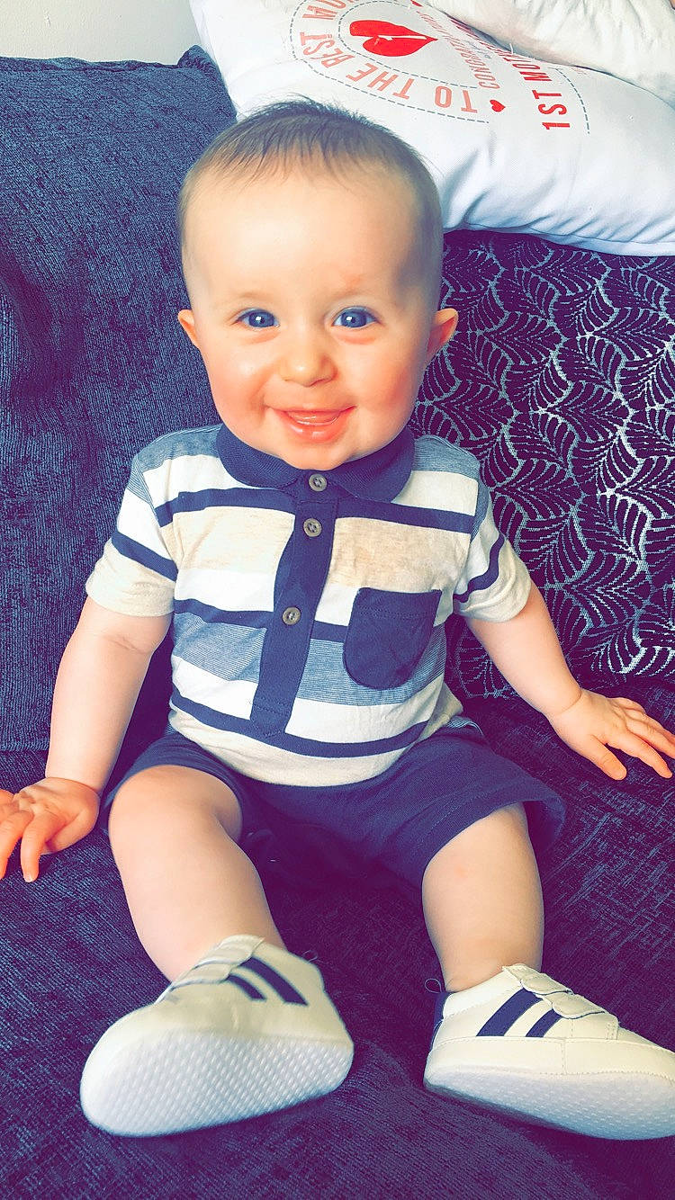 Fraser is registered to the contest to win money with this photo: baby, baby_products, baby_toddler_clothing, cheek, child, child_model, cool, head, joy, leg, pattern, person, play, shoe, sitting, skin, sleeve, smile, t_shirt, toddler