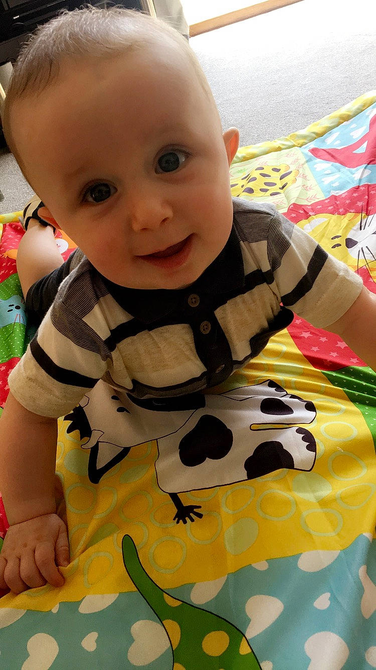 Fraser is registered to the contest to win money with this photo: baby, baby_products, baby_toddler_clothing, baby_toys, cheek, child, eye, head, linens, nap_mat, nose, pattern, person, play, skin, sleeve, smile, textile, toddler, tummy_time