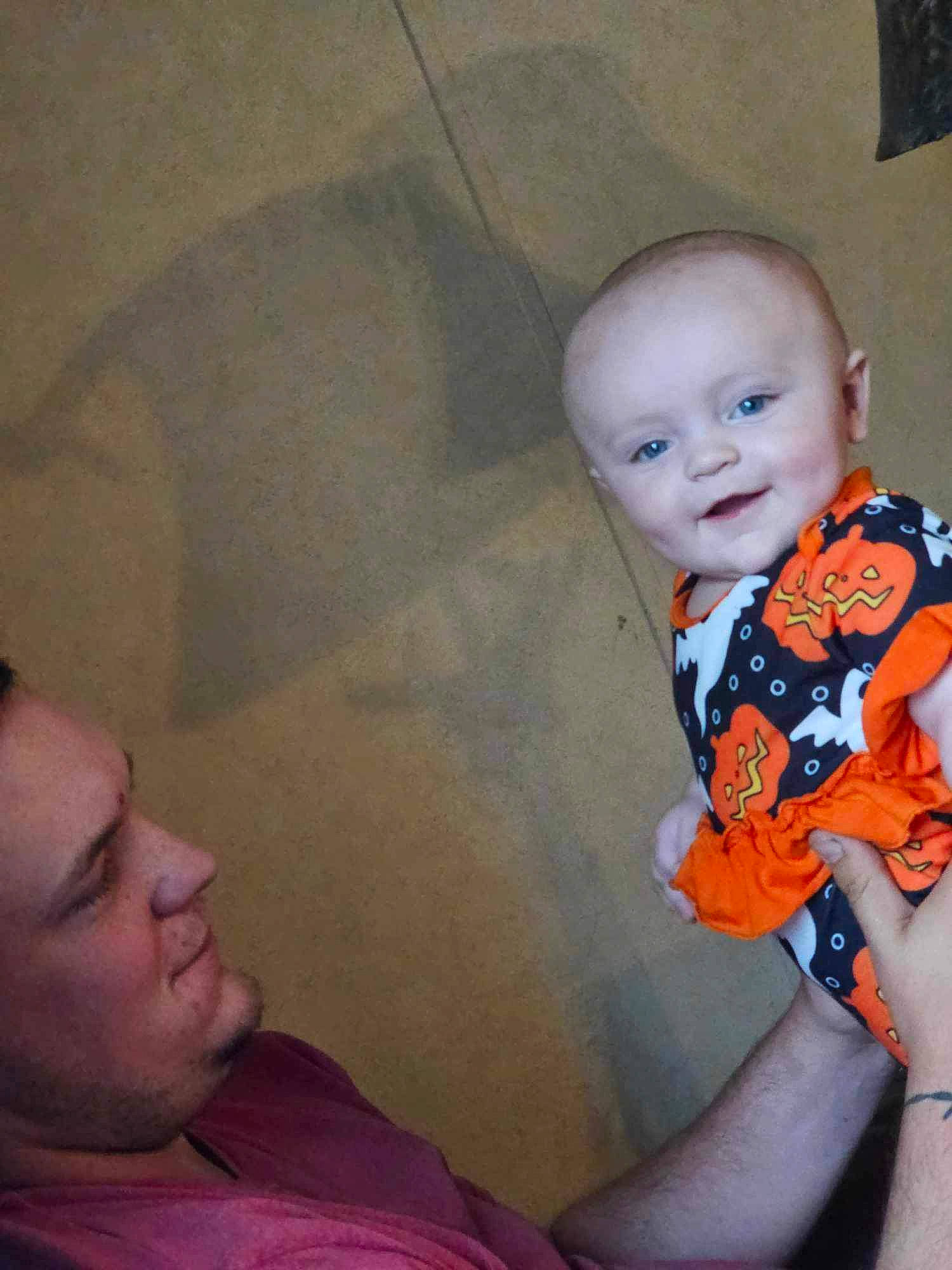 Laramie is registered to the contest to win money with this photo: baby, baby_toddler_clothing, cheek, chin, comfort, eyebrow, fun, gesture, hand, happy, iris, joy, lip, mouth, neck, nose, person, shoulder, sitting, skin