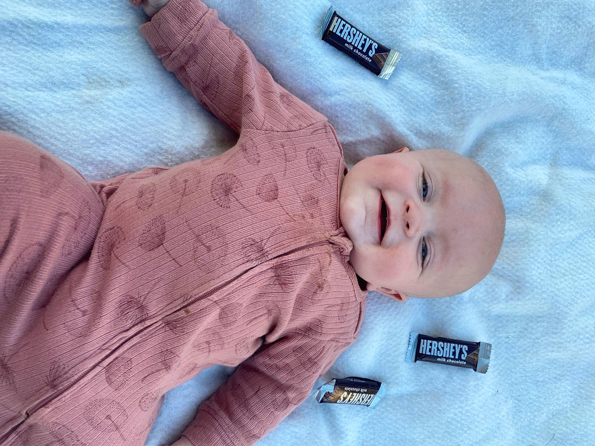 Laramie is registered to the contest to win money with this photo: baby, baby_products, baby_sleeping, baby_toddler_clothing, child, comfort, electric_blue, gesture, linens, magenta, nail, pattern, person, portrait_photography, skin, sleeve, smile, textile, thumb, toddler