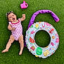Adèle participe au concours pour gagner de l'argent avec cette photo : baby, child, swimsuit, sunglasses, grass, inflatable_ring, watering_can, summer, outdoor, playtime, happy, smiling, pink, green, toy, cute, fun, lying_down, sunny, vacation