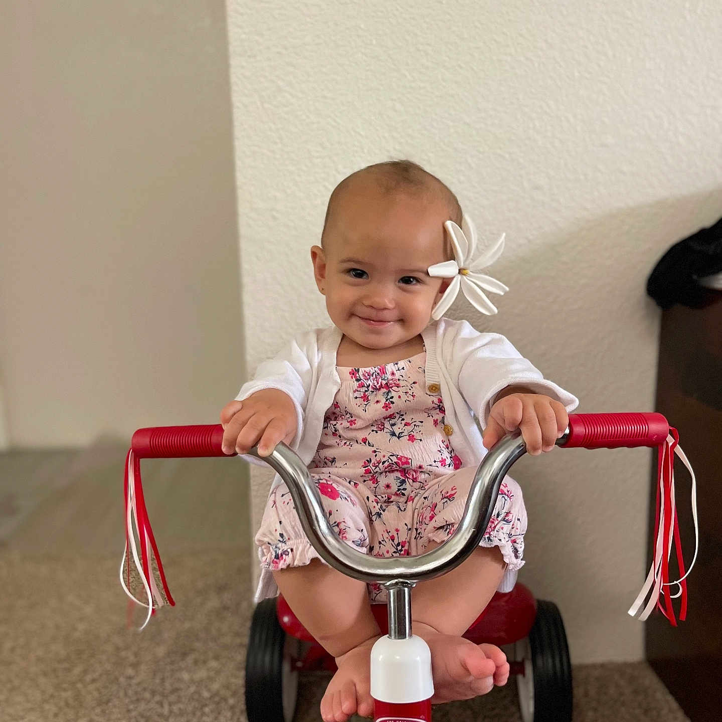 Weslynn is registered to the contest to win money with this photo: baby, clothing, dress, face, footwear, happy, head, helmet, machine, person, photography, portrait, racket, shoe, sitting, smile, transportation, tricycle, vehicle, wheel