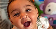 Zayden is registered to the contest to win money with this photo: baby, child, toddler, smiling, happy, surprised, portrait, close_up, face, eyes, open_mouth, indoor, playroom, toys, stuffed_animal, colorful, sitting, leaning, short_hair, photography