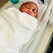 Mckenzie is registered to the contest to win money with this photo: newborn, baby, infant, hospital, bassinet, blanket, cap, sleeping, footprints, personalized, resting, wrapped, cute, child, healthcare, medical, crib, portrait, peaceful, indoors