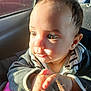 baby, car_interior, cheek, child, closeup, curious, cute, ear, eyes, face, hair, hand, infant, portrait, seat, shadow, skin, striped_clothing, sunlight, window