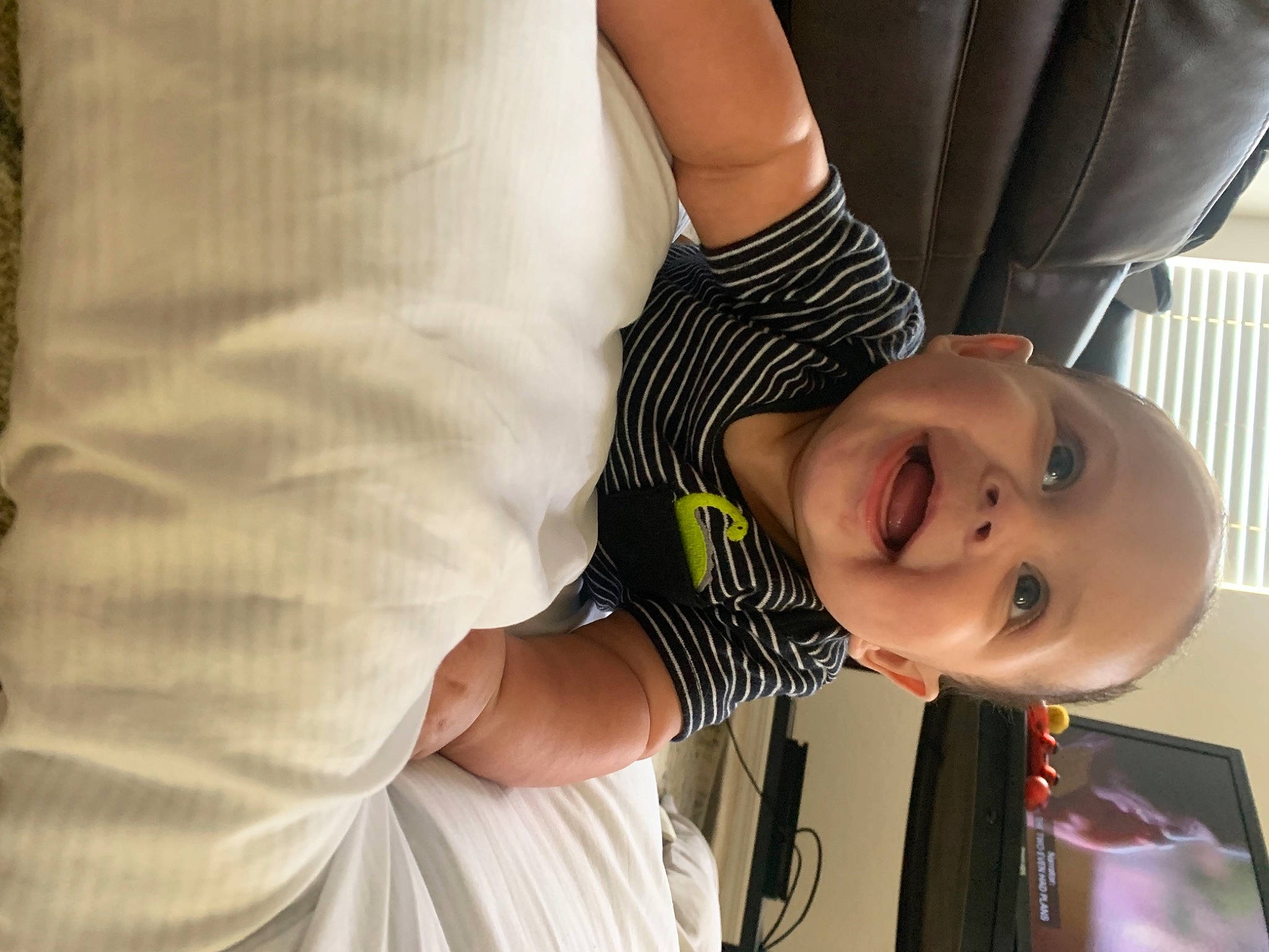 Andre is registered to the contest to win money with this photo: baby, baby_toddler_clothing, child, comfort, dress, elbow, eyelash, fun, gesture, glasses, happy, human_body, mouth, nose, person, skin, sleeve, smile, t_shirt, toddler