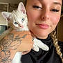 Freya participe au concours pour gagner de l'argent avec cette photo : woman, kitten, cat, tattoo, braid, indoor, portrait, holding, pet, cute, white_cat, blue_eyes, smile, hand, face, young_adult, casual, black_shirt, close_up, affection