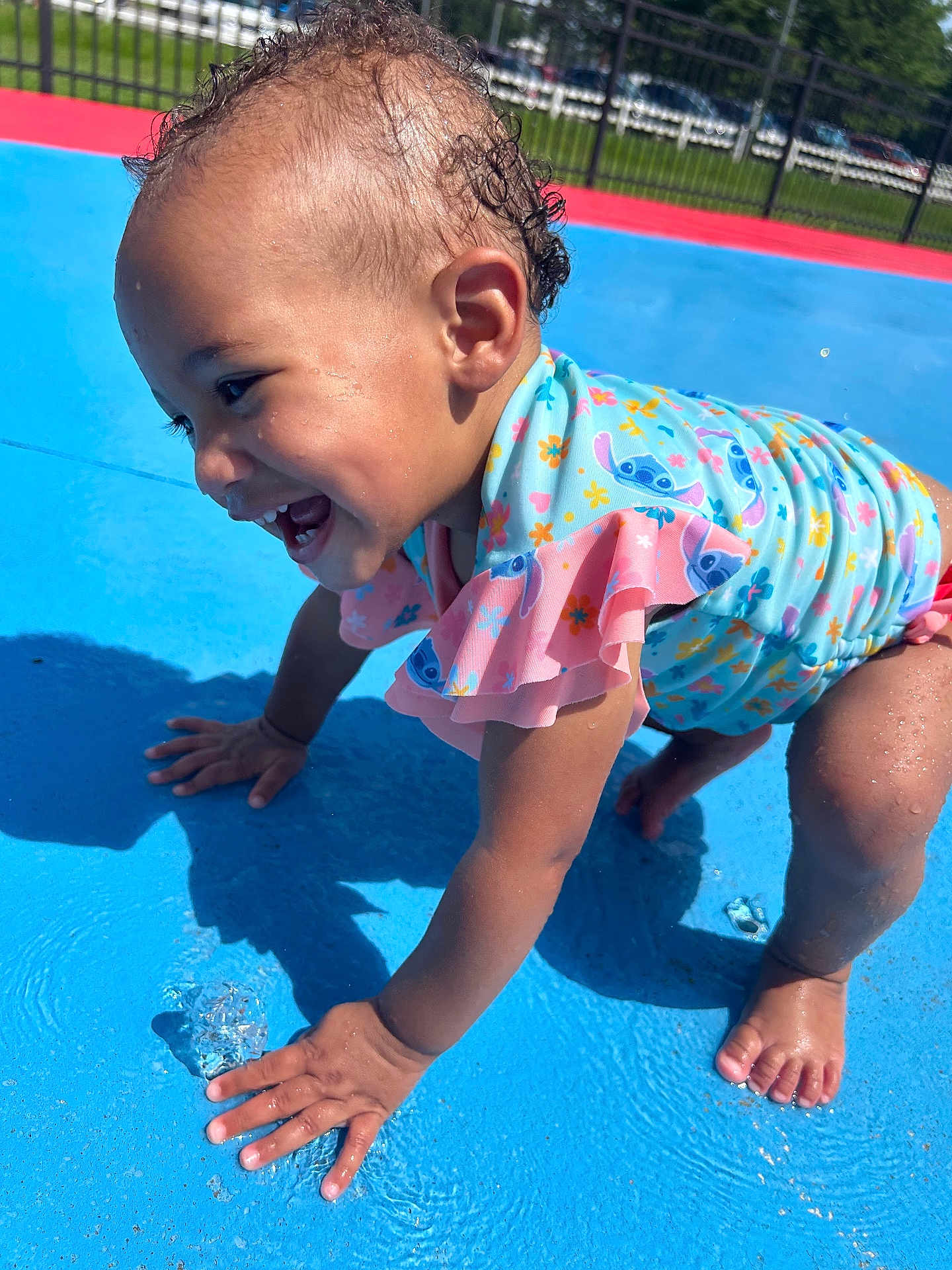 Jade joined the competition — help win amazing prizes! toddler, child, water, splash, swimsuit, outdoor, play, happy, smile, sunlight, skin, hand, foot, blue, colorful, summer, fun, wet, cute, joy