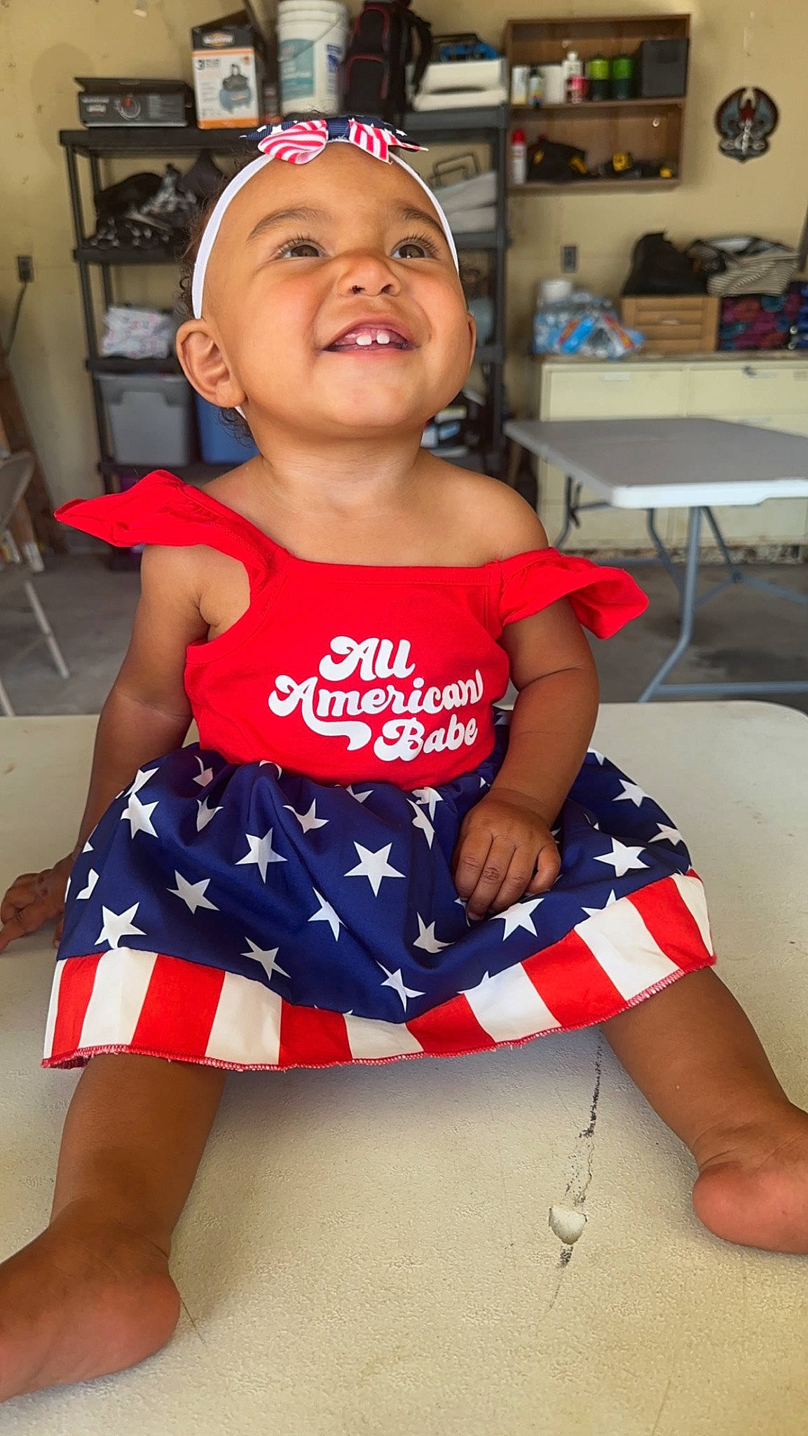 Jaziyah joined the competition — help win amazing prizes! baby_toddler_clothing, chair, child, elbow, electric_blue, fun, happy, head, human_leg, joy, knee, neck, pattern, person, red, sitting, skin, sleeve, smile, thigh