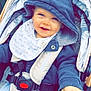 baby, child, stroller, hood, blue_clothing, bib, smile, happy, outdoor, hand, seatbelt, jacket, infant, person, cute, portrait, young, baby_boy, clothing, warm