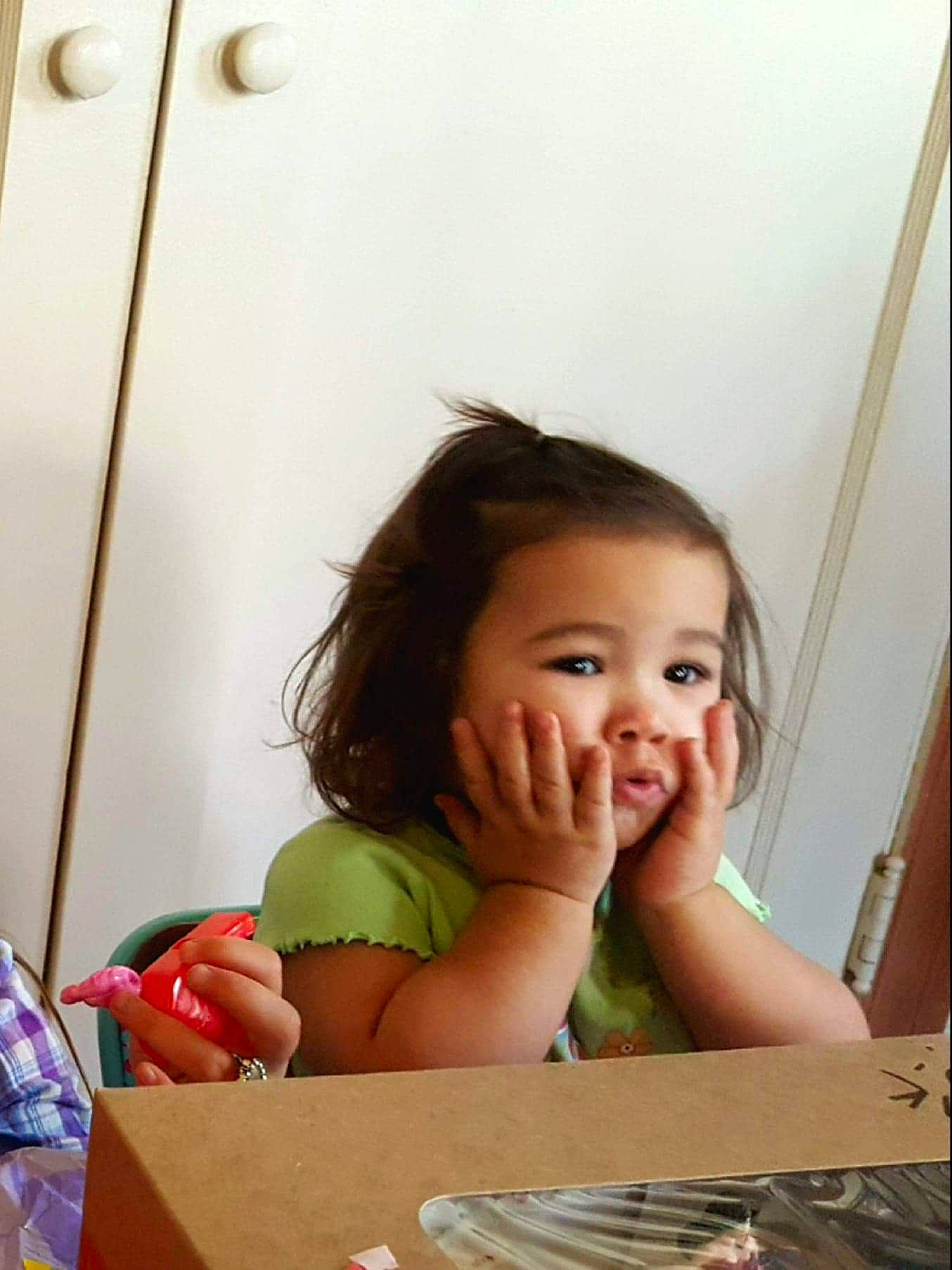 Carmella joined the competition — help win amazing prizes! baby, cheek, child, face, facial_expression, finger, flooring, fun, happy, human, nose, people, person, play, sitting, skin, summer, table, toddler, window