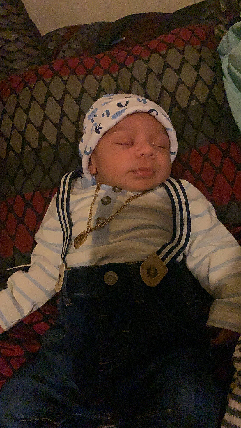 Carlos joined the competition — help win amazing prizes! baby, baby_products, baby_toddler_clothing, beanie, cap, cheek, child, comfort, freezing, fun, headwear, hood, hoodie, knit_cap, mesh, pattern, person, personal_protective_equipment, sitting, sleeve