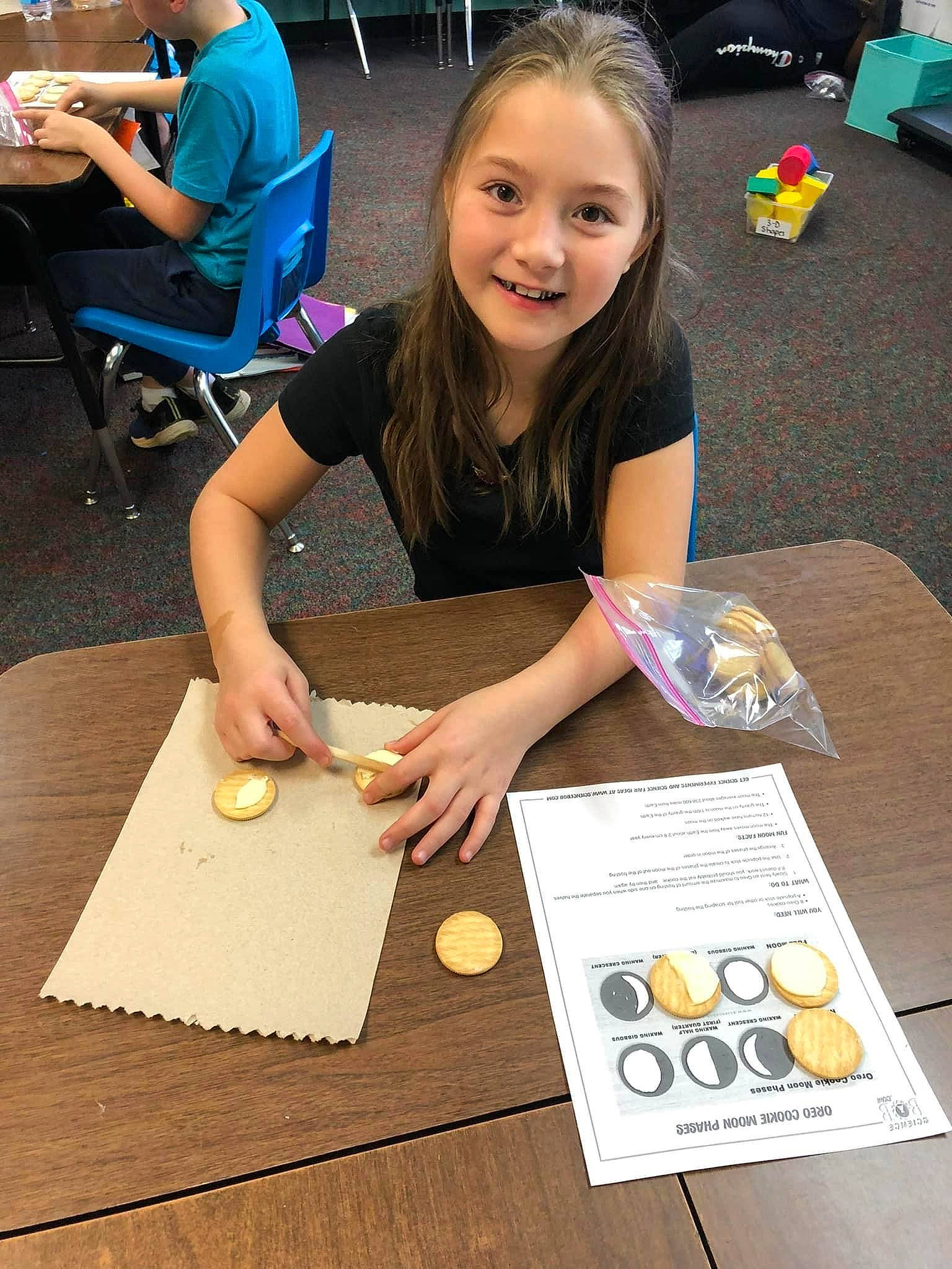 Jacquelyn is registered to the contest to win money with this photo: chair, child, event, finger, flooring, fun, hand, joy, learning, leisure, nail, person, play, recreation, smile, t_shirt, table, tableware, toddler, toy