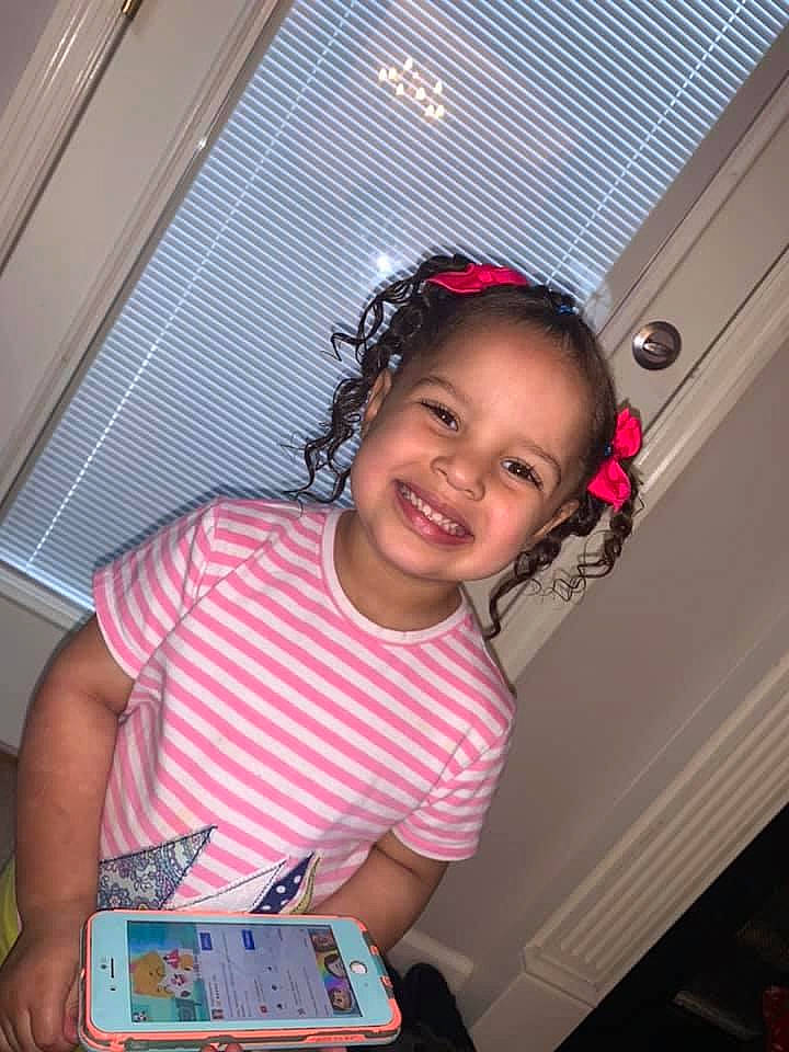 Kynslee Elizabeth is registered to the contest to win money with this photo: audio_equipment, baby_toddler_clothing, box, child, dress, electronic_device, facial_expression, fun, hairstyle, happy, joy, magenta, person, pink, plaid, room, sitting, skin, smile, standing