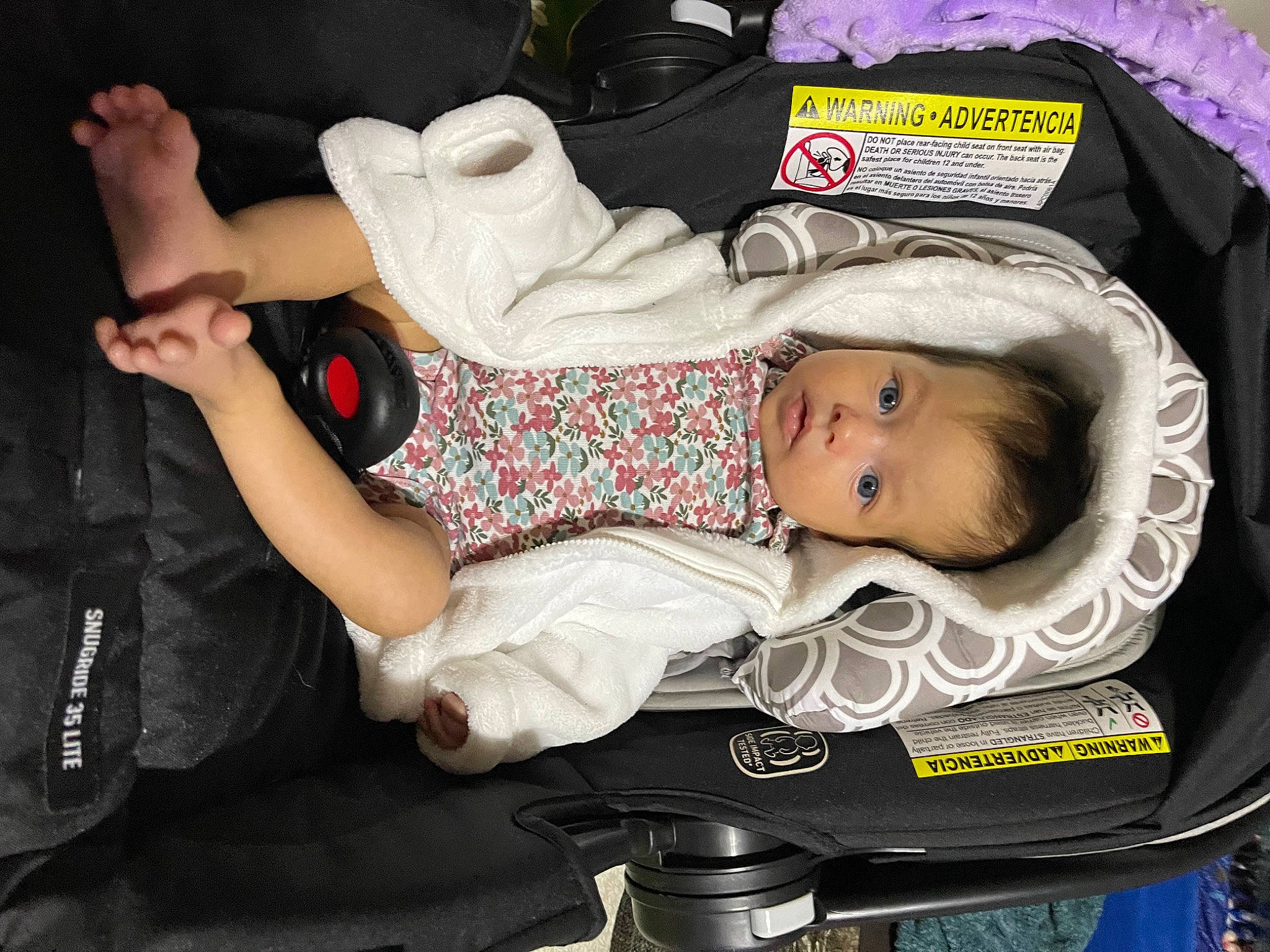 Mira is registered to the contest to win money with this photo: baby, baby_carriage, baby_products, baby_toddler_clothing, car_seat, child, comfort, event, facial_expression, fashion, fun, hand, hat, lap, luggage_and_bags, person, room, sitting, thigh, toddler