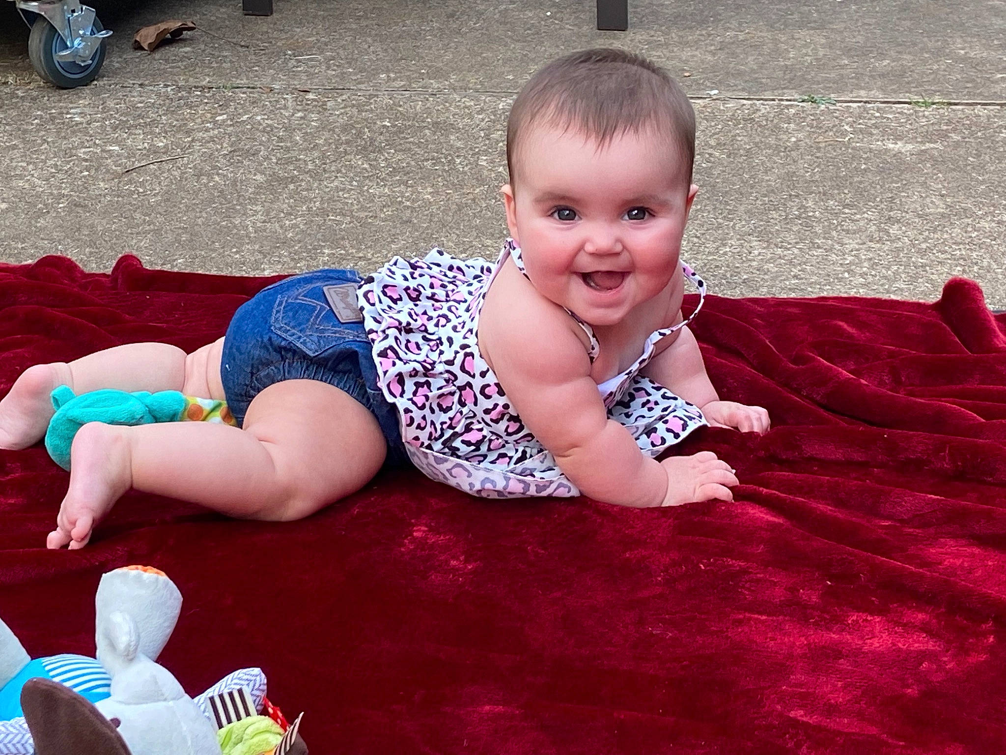 Jolene is registered to the contest to win money with this photo: baby, baby_toddler_clothing, crawling, event, eye, facial_expression, flooring, foot, fun, grass, happy, human_leg, joy, leg, leisure, person, pink, sitting, smile, sock