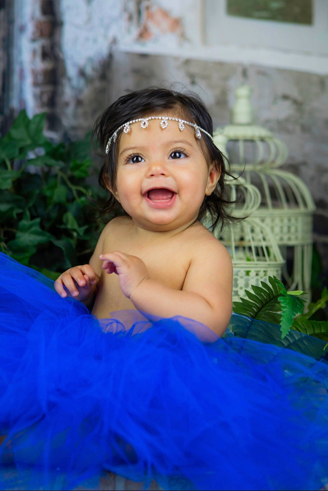 Amilia is registered to the contest to win money with this photo: baby, blue, cheek, child, child_model, dress, eye, face, facial_expression, fun, hair_accessory, happy, head, headgear, headpiece, person, photography, skin, smile, toddler