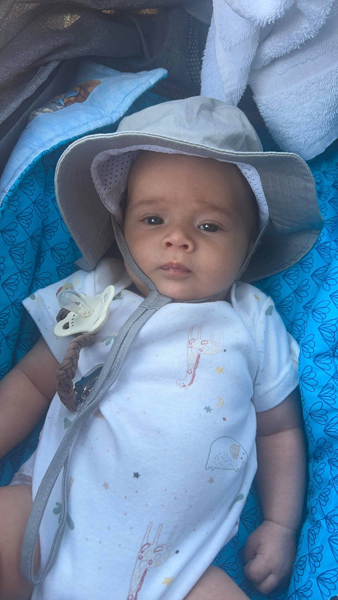 Julian is registered to the contest to win money with this photo: baby, baby_products, baby_toddler_clothing, blue, cap, cheek, child, eyelash, fashion_accessory, fun, happy, hat, iris, lip, person, sitting, skin, sleeve, smile, sun_hat