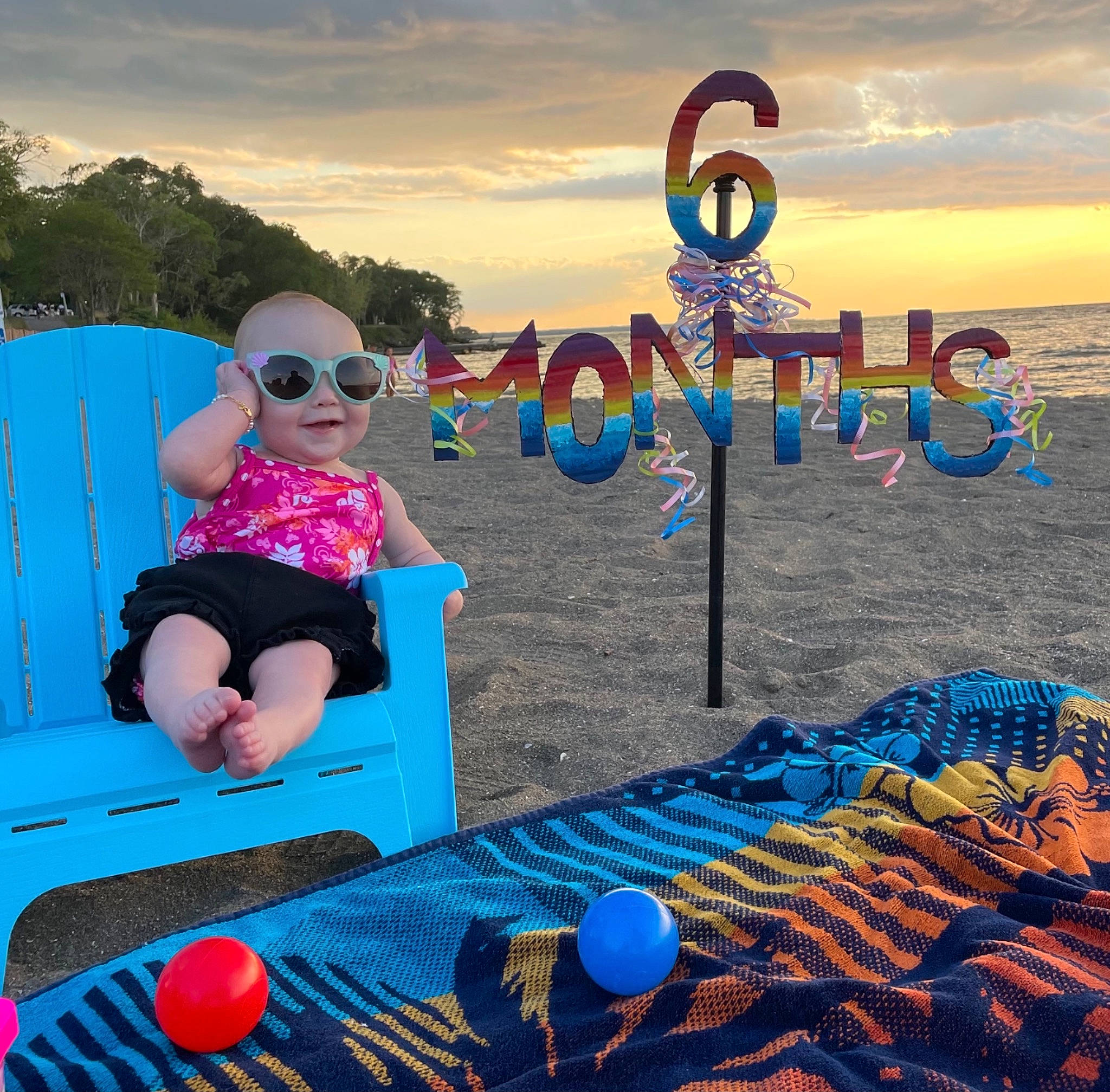 Emelia is registered to the contest to win money with this photo: automotive_tire, azure, baby_toddler_clothing, blue, cloud, fun, goggles, happy, human, leisure, light, nature, person, photograph, shorts, sky, smile, sunglasses, travel, vision_care