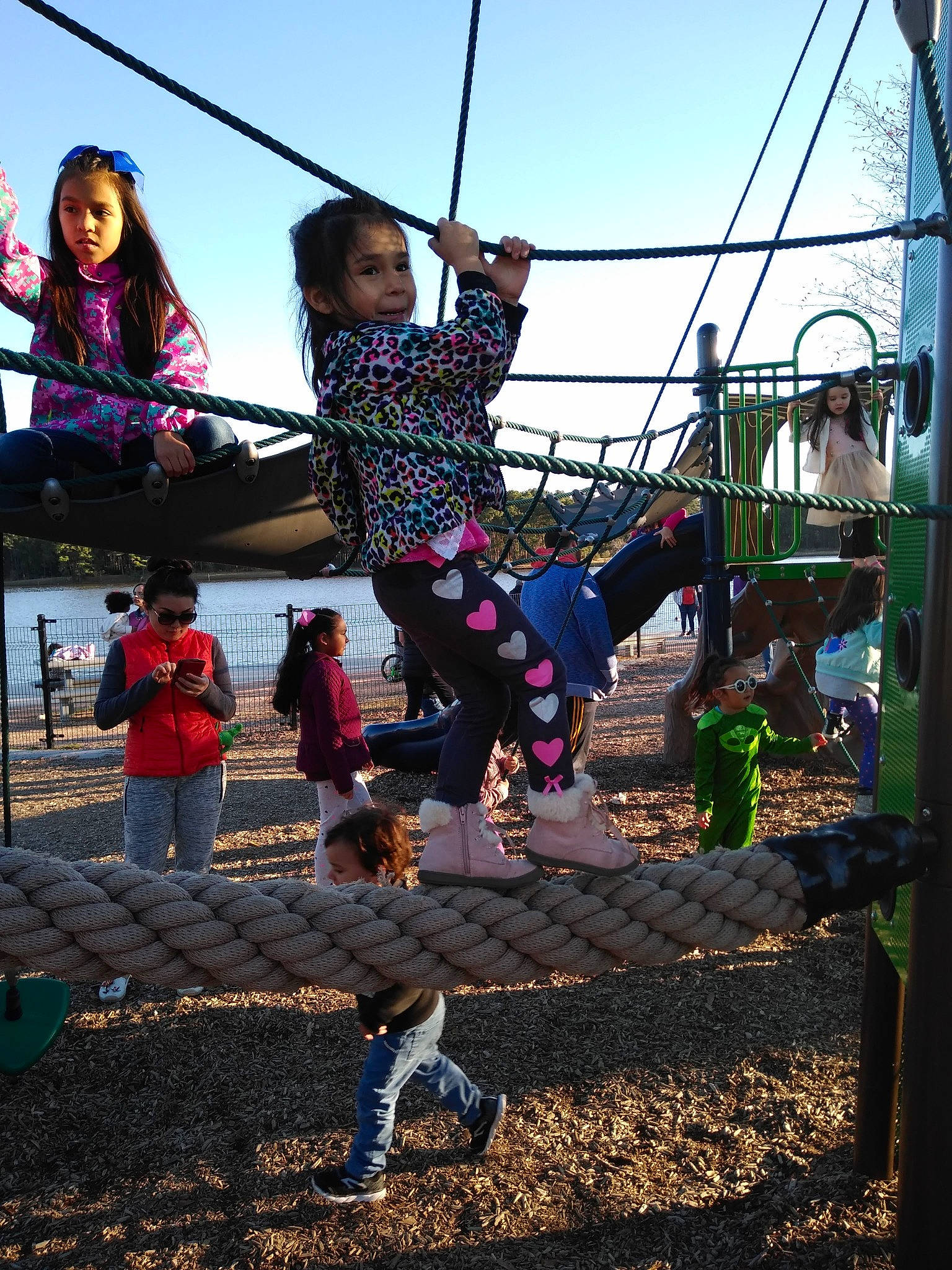 Clara joined the competition — help win amazing prizes! child, city, community, fun, human_settlement, leisure, outdoor_play_equipment, performance, person, plant, play, playground, public_space, recreation, rope, sky, smile, swing, toddler, trampoline