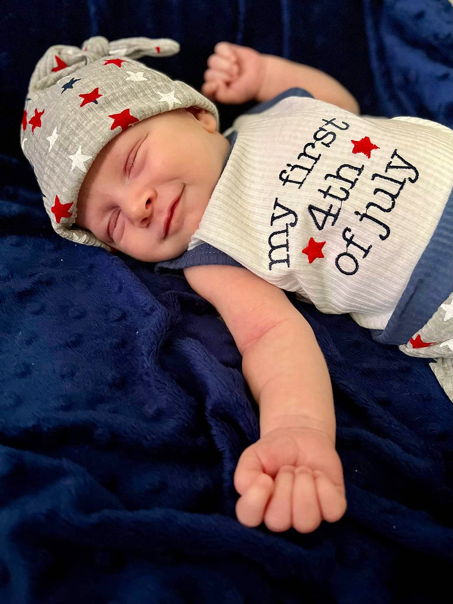 Jaxon is registered to the contest to win money with this photo: baby, baby_toddler_clothing, cap, child, comfort, elbow, font, foot, grass, happy, hat, head, headwear, human_leg, joy, pattern, person, sitting, skin, sleeve