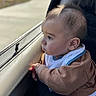 Elias joined the competition — help win amazing prizes! baby, child, car, window, looking_out, curious, hands, clothing, bib, portrait, side_view, natural_light, indoor, person, young_child, seat, soft_light, closeup, face, expression