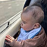 baby, child, car, window, hand, face, profile, curious, clothing, sweater, bib, seat, skin, hair, person, indoor, natural_light, young, cute, infant