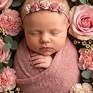 Luna is registered to the contest to win money with this photo: newborn, baby, sleeping, pink, blanket, flower_crown, roses, carnations, floral_arrangement, portrait, closeup, peaceful, soft_texture, headband, infant, cute, wrapped, hands, delicate, nature