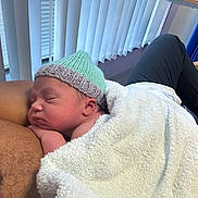 Junior joined the competition — help win amazing prizes! newborn, baby, sleeping, hat, towel, adult, chest, indoor, window, blinds, person, rest, peaceful, skin, furniture, chair, closeup, relaxation, warmth, cozy