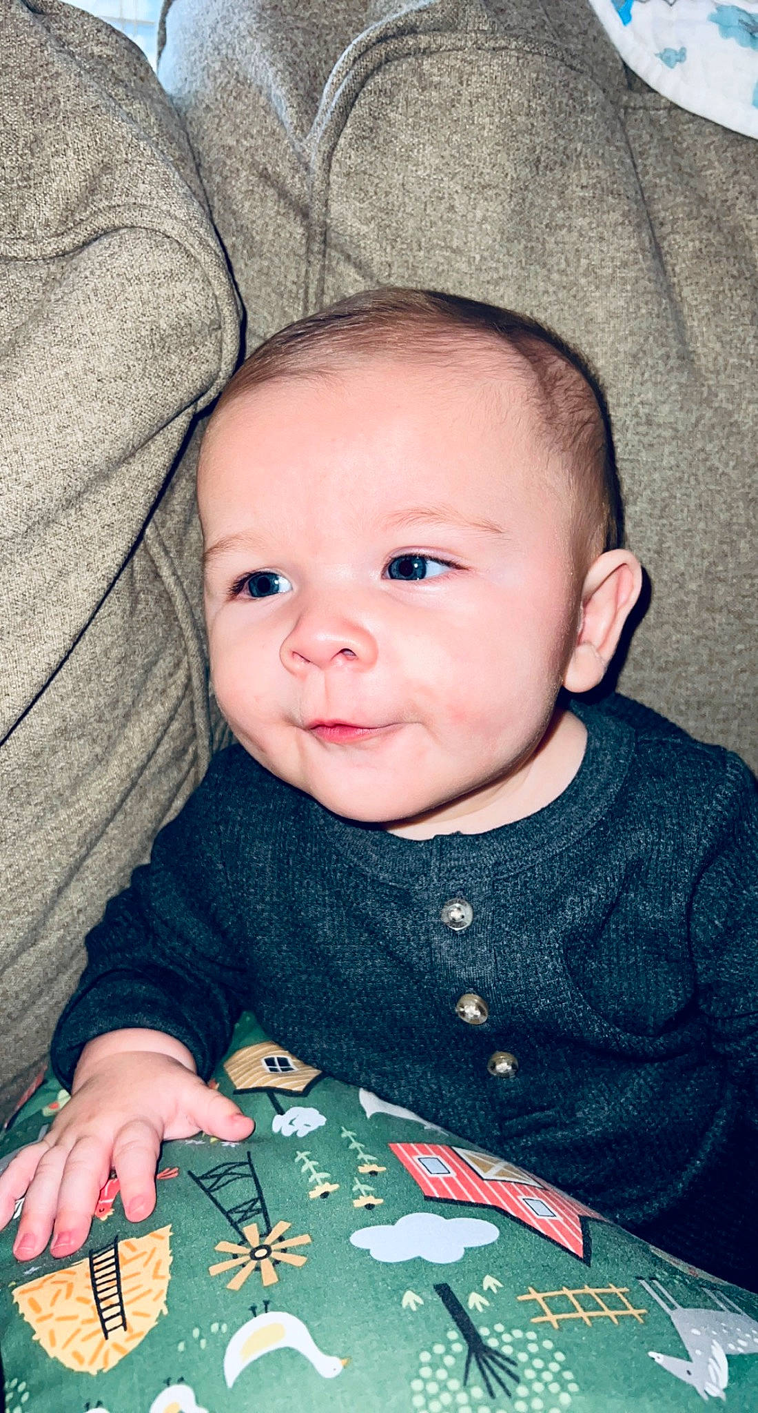 Charlie is registered to the contest to win money with this photo: baby, baby_toddler_clothing, cheek, child, comfort, eyelash, happy, iris, linens, lip, nose, pattern, person, sitting, skin, sleeve, smile, t_shirt, textile, toddler