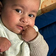 David joined the competition — help win amazing prizes! baby, infant, close_up, face, hand, knit_sweater, bib, cute, expression, skin, fingers, portrait, child, young, indoors, comfort, warm, soft, curious, cozy