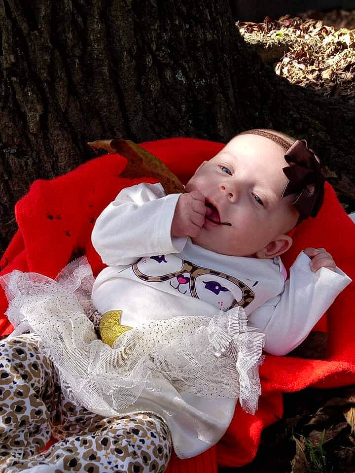 Madelyn joined the competition — help win amazing prizes! baby, baby_toddler_clothing, carmine, cheek, child, fur, grass, happy, pattern, people_in_nature, person, plant, portrait_photography, sitting, toddler, tree, winter