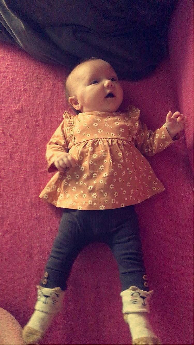 Mya participe au concours pour gagner de l'argent avec cette photo : baby, baby_toddler_clothing, cheek, child, doll, head, human_body, leg, lip, mouth, nose, organ, person, pink, purple, skin, sleeve, textile, tints_and_shades, toy