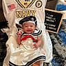 baby, baby_pose, carpet, couch, cute, flag_patch, floor_rug, happy, indoor, infant, letter_board, military_theme, navy_jersey, navy_patch, portrait, sailor_hat, sailor_outfit, smile, socks, white_dress