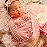 baby, basket, blanket, closeup, cozy, faux_fur, feet, flowers, hands, headband, infant, newborn, peaceful, pink, portrait, props, sleeping, soft_texture, studio_photography, swaddle