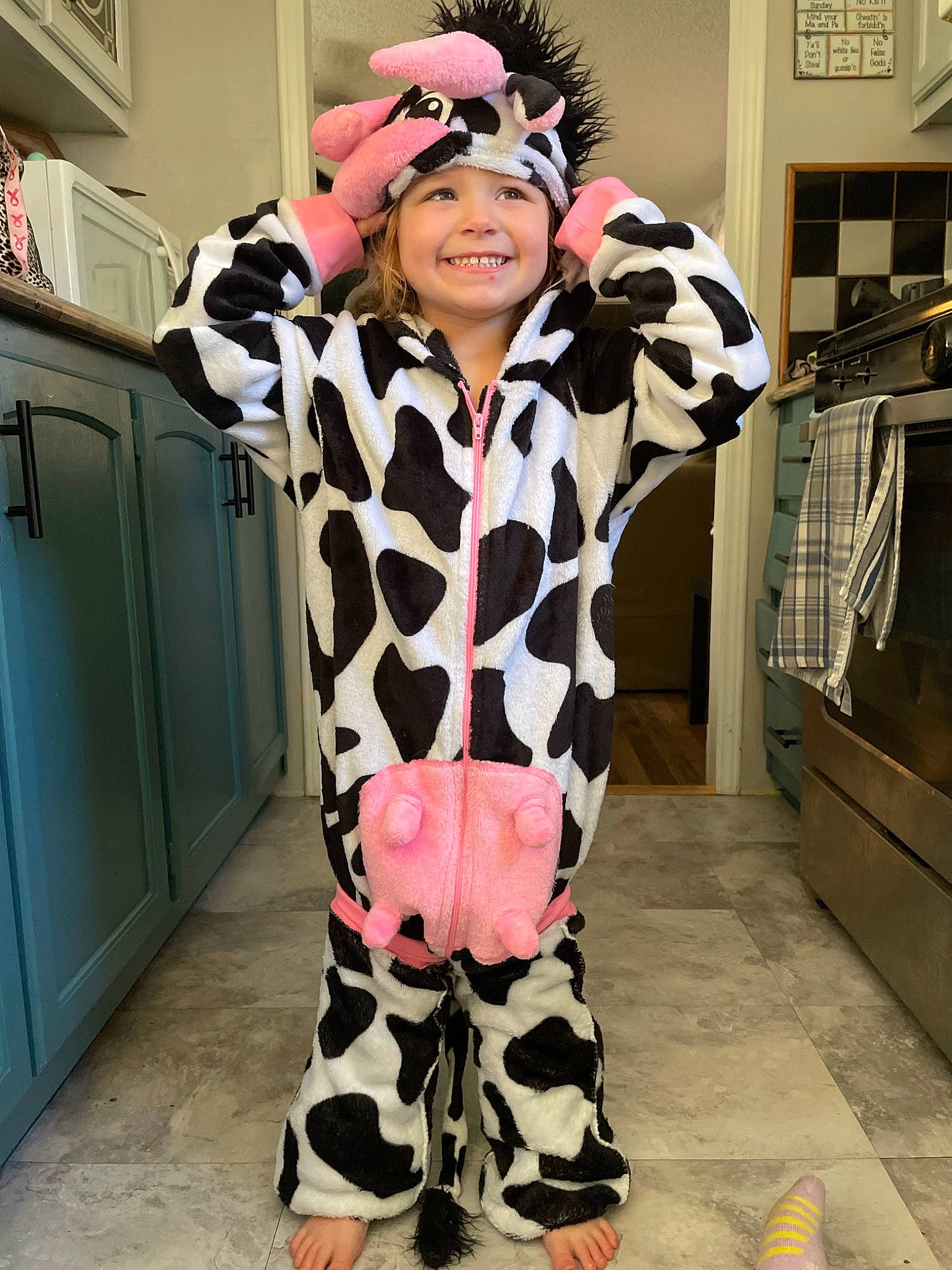 Ember is registered to the contest to win money with this photo: camouflage, child, cool, costume, eyewear, fashion_design, flooring, fun, fur, headgear, headwear, joy, military_camouflage, outerwear, pattern, person, personal_protective_equipment, pink, refrigerator, sleeve