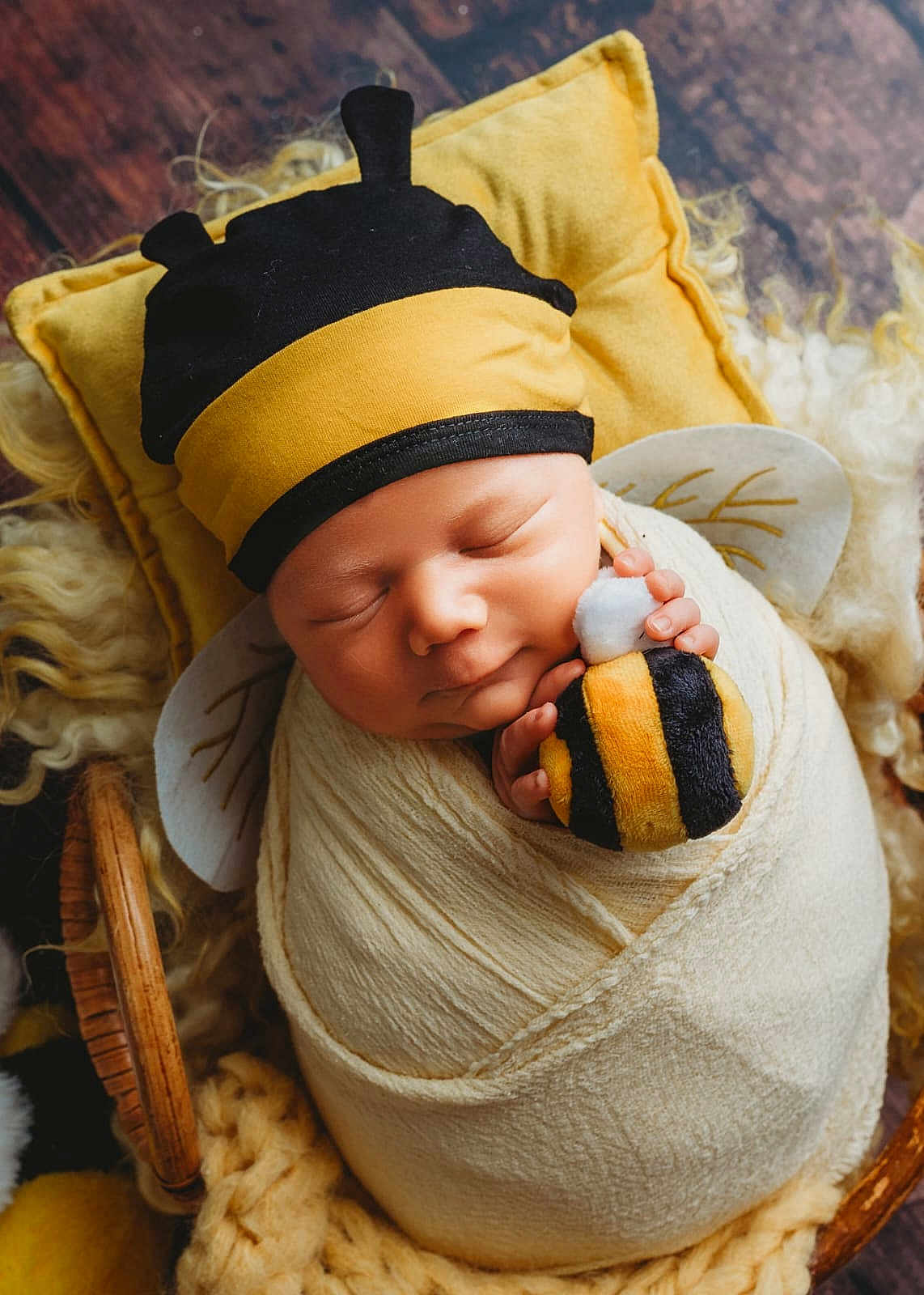 Harlow joined the competition — help win amazing prizes! newborn, baby, swaddled, blanket, bee_hat, plush_toy, sleeping, pillow, wooden_floor, cute, infant, soft_texture, yellow, black, white, child, portrait, cozy, peaceful, resting