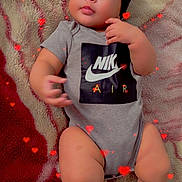 Kaileth is registered to the contest to win money with this photo: baby, infant, onesie, nike, socks, blanket, heart_effects, cute, chubby, indoor, portrait, child, young, fashion, laying_down, cozy, soft_texture, adorable, casual, relaxed