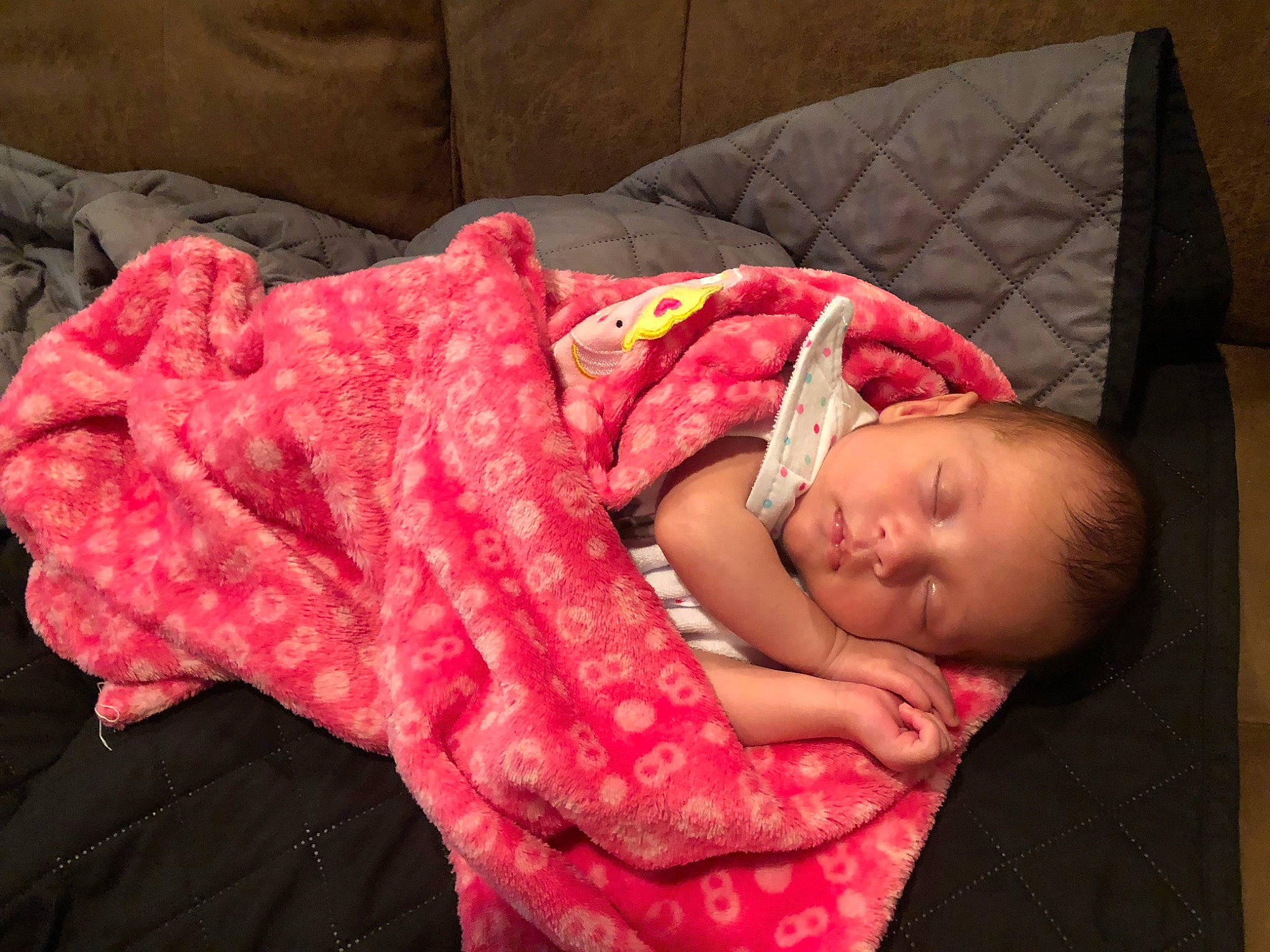 Nola is registered to the contest to win money with this photo: baby, baby_products, baby_toddler_clothing, bedding, bedtime, carmine, child, comfort, couch, flesh, human_body, human_leg, linens, magenta, nap, person, room, sitting, skin, sleep