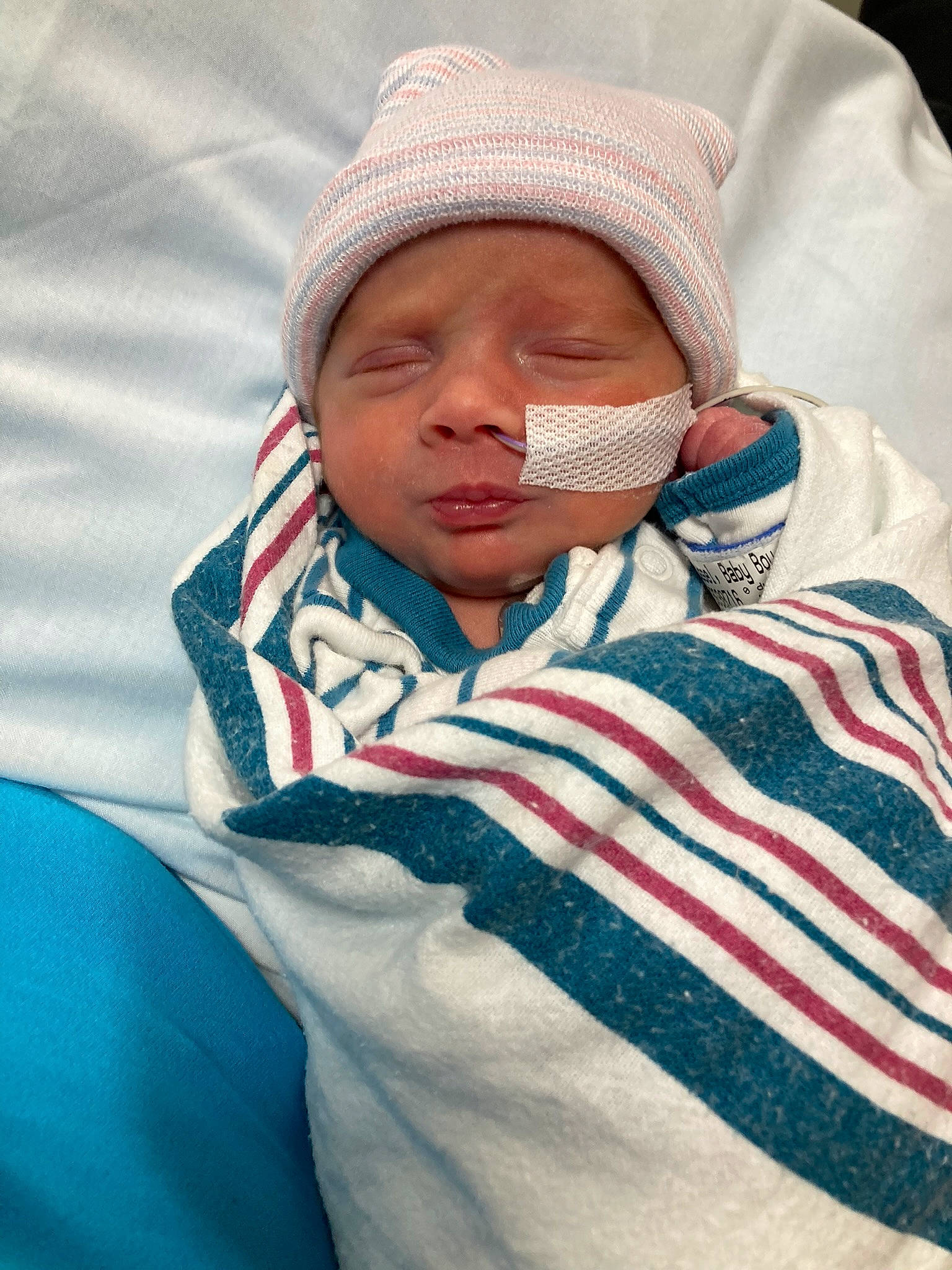 Colter is registered to the contest to win money with this photo: baby, baby_sleeping, cap, cheek, child, comfort, cool, electric_blue, eyebrow, happy, hat, headwear, knit_cap, linens, lip, mouth, nose, outerwear, person, sleeve