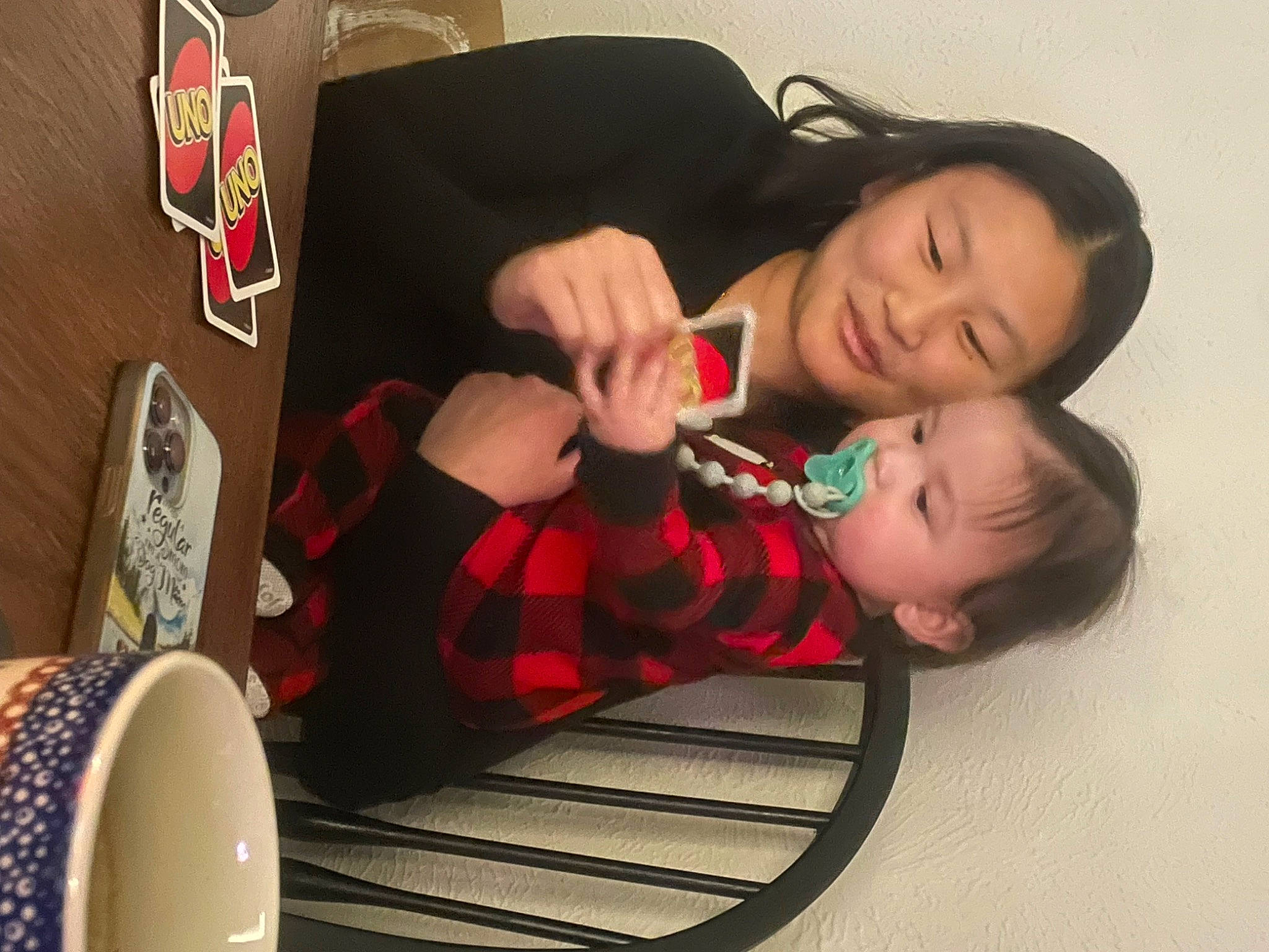 Maximus Sean is registered to the contest to win money with this photo: baby, carmine, chair, child, comfort, dress, flooring, fun, happy, human_leg, joy, pattern, person, plaid, room, sitting, sock, tableware, tartan, thigh