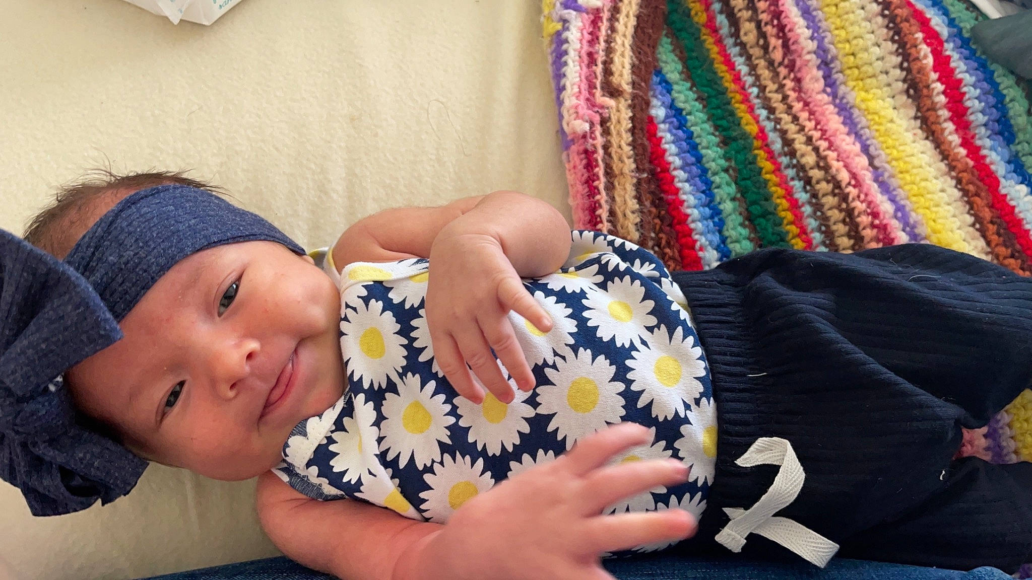 Jocelyn is registered to the contest to win money with this photo: arm, black_hair, comfort, elbow, eye, finger, hand, happy, headgear, headwear, human_body, lip, neck, outerwear, pattern, person, skin, sleeve, smile, textile