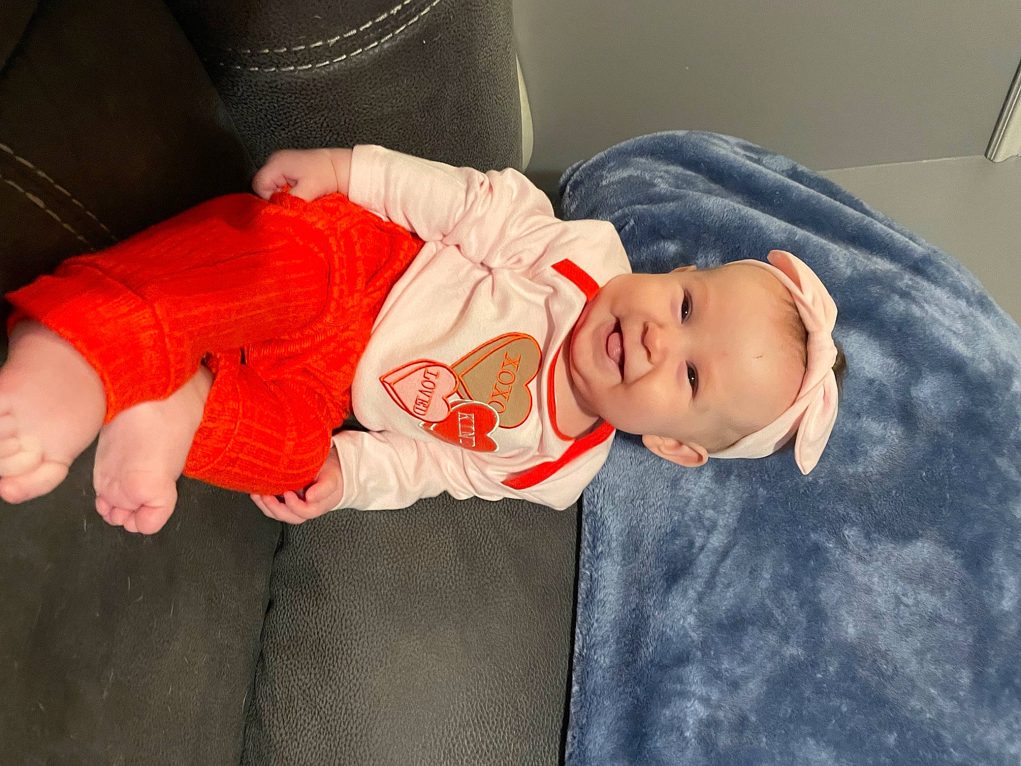 Eliza joined the competition — help win amazing prizes! baby, baby_products, baby_toddler_clothing, cheek, child, comfort, face, foot, hat, headgear, human_leg, joy, lap, person, room, sitting, skin, sleeve, sock, thigh