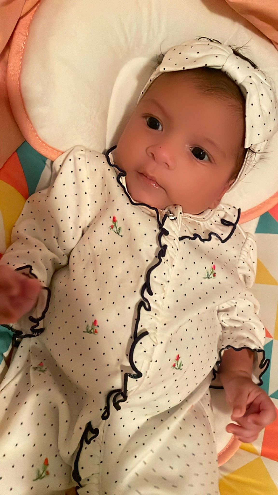 Gabriella is registered to the contest to win money with this photo: baby, baby_toddler_clothing, cap, cheek, collar, dress_shirt, facial_expression, lip, one_piece_garment, outerwear, pattern, person, photograph, pink, product, skin, sleeve, sun_hat, textile, toddler